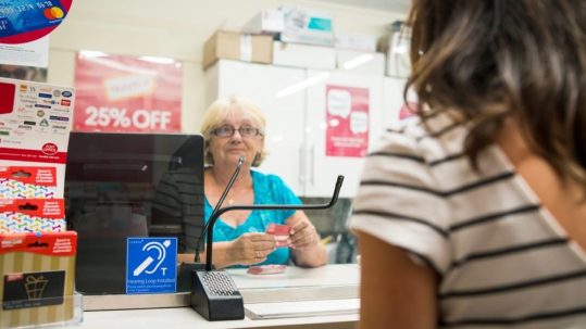 Woman being served at Post Office