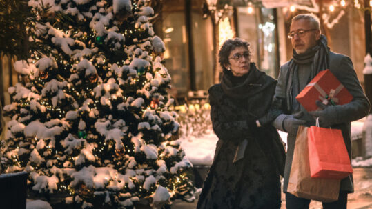 Couple walking outdoors at Christmas time