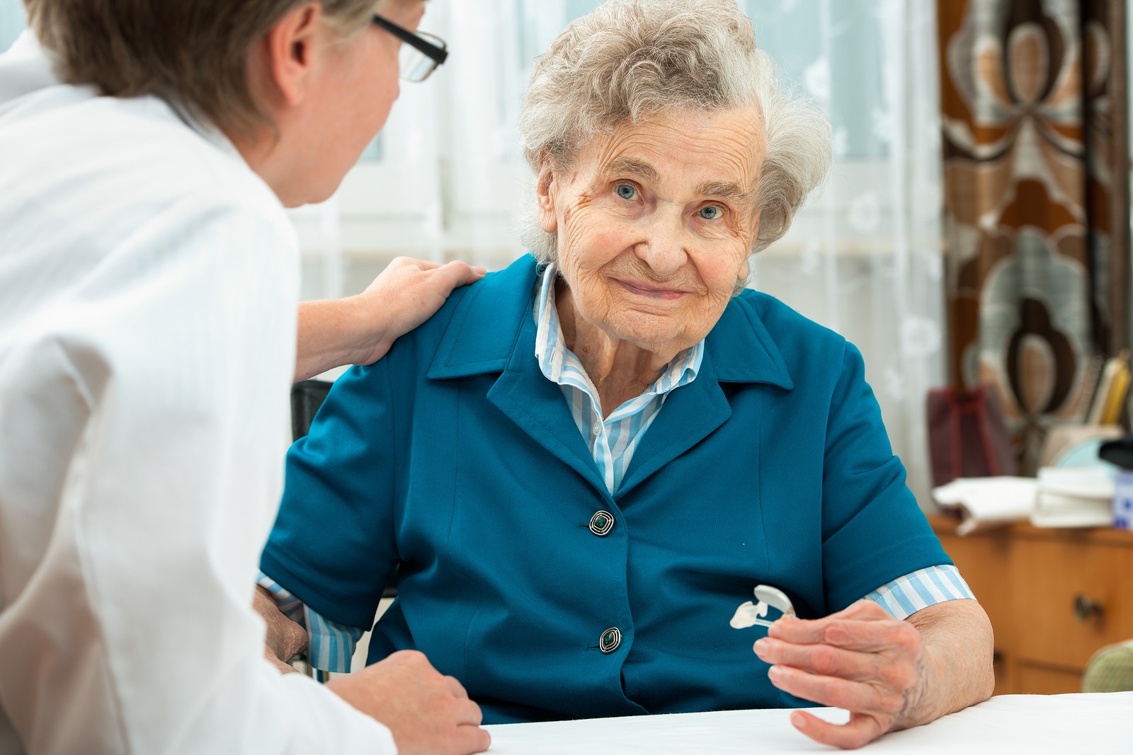 Elderly person with hearing aid