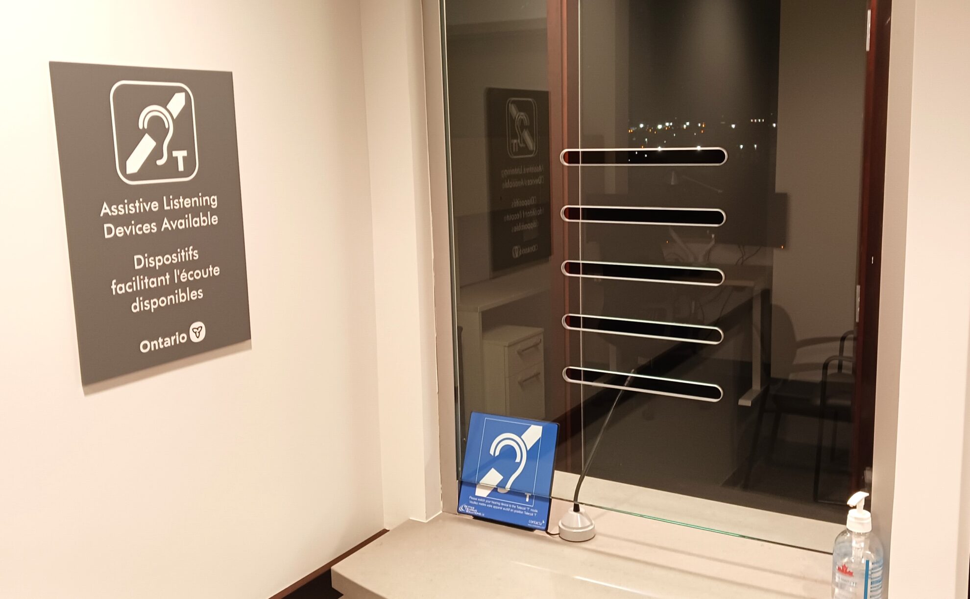 Window intercom system with multi-lingual hearing loop signs